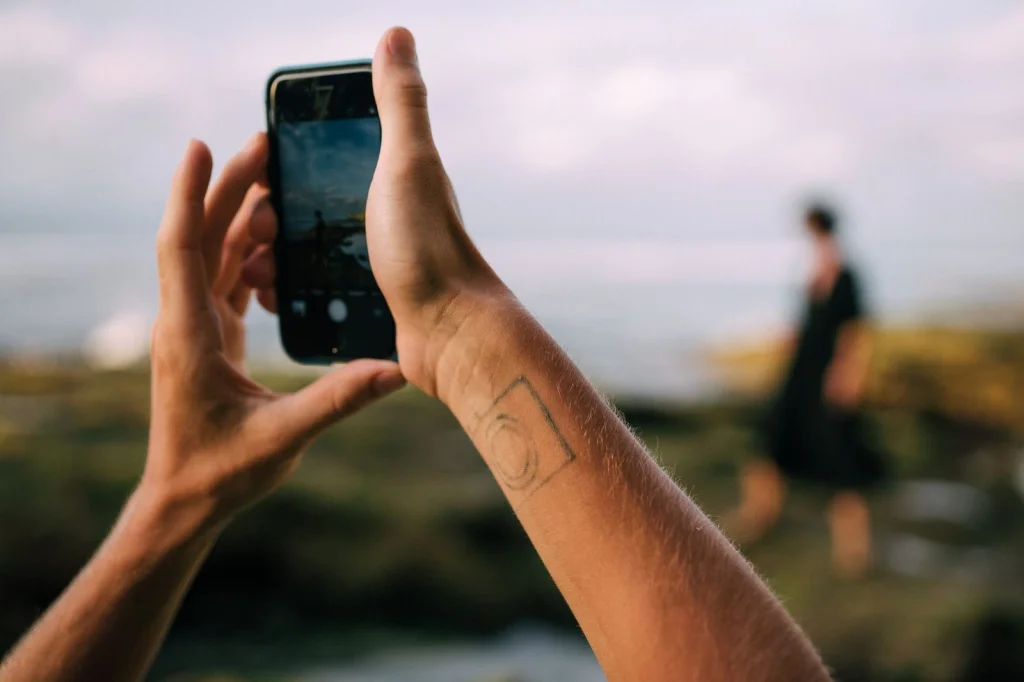 Person holding smartphone at arm