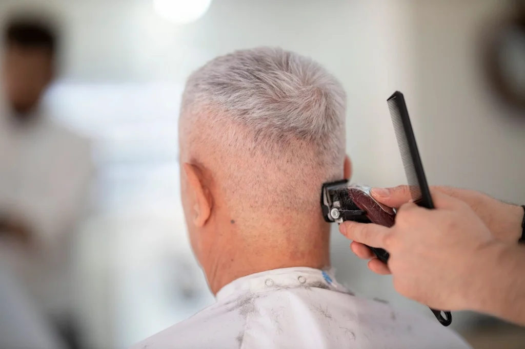 Professional barber cutting man
