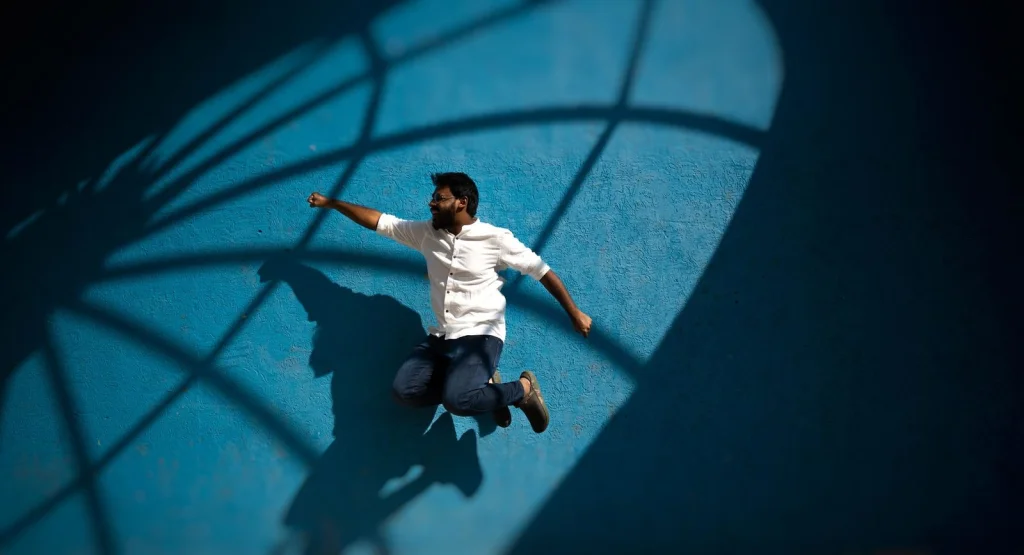 Creative photo montage showing a person appearing to jump through different scenic backgrounds, demonstrating background removal and replacement technique, dynamic composition, colorful lighting, wide angle shot, digital art photography style