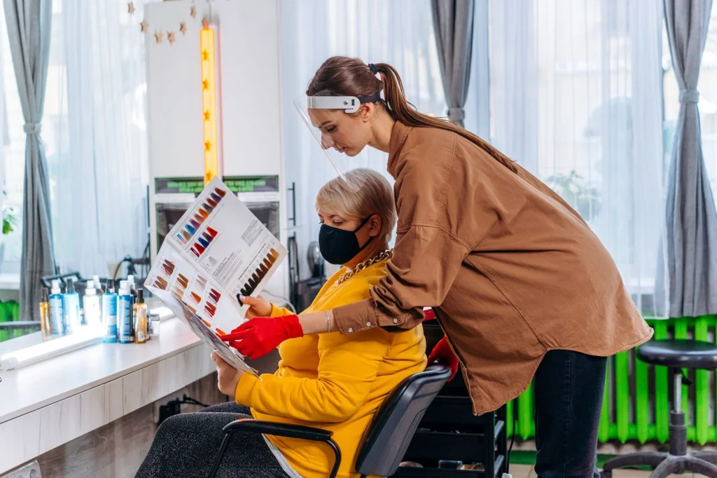 Professional hairstylist consulting with a client while looking at AI-generated hairstyle options on a tablet, modern salon setting with good lighting, candid consultation photography