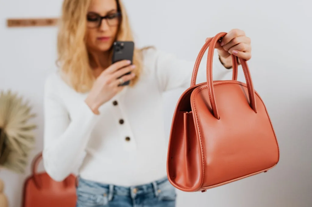 E-commerce product shot of a vintage leather handbag in brown, positioned on a white seamless background, bright even studio lighting, straight-on product angle, commercial photography, crisp focus