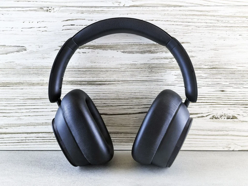 Sleek black wireless headphones on white background with perfect transparent edges, no shadows, centered composition, bright even lighting, overhead flat-lay shot, commercial product photography