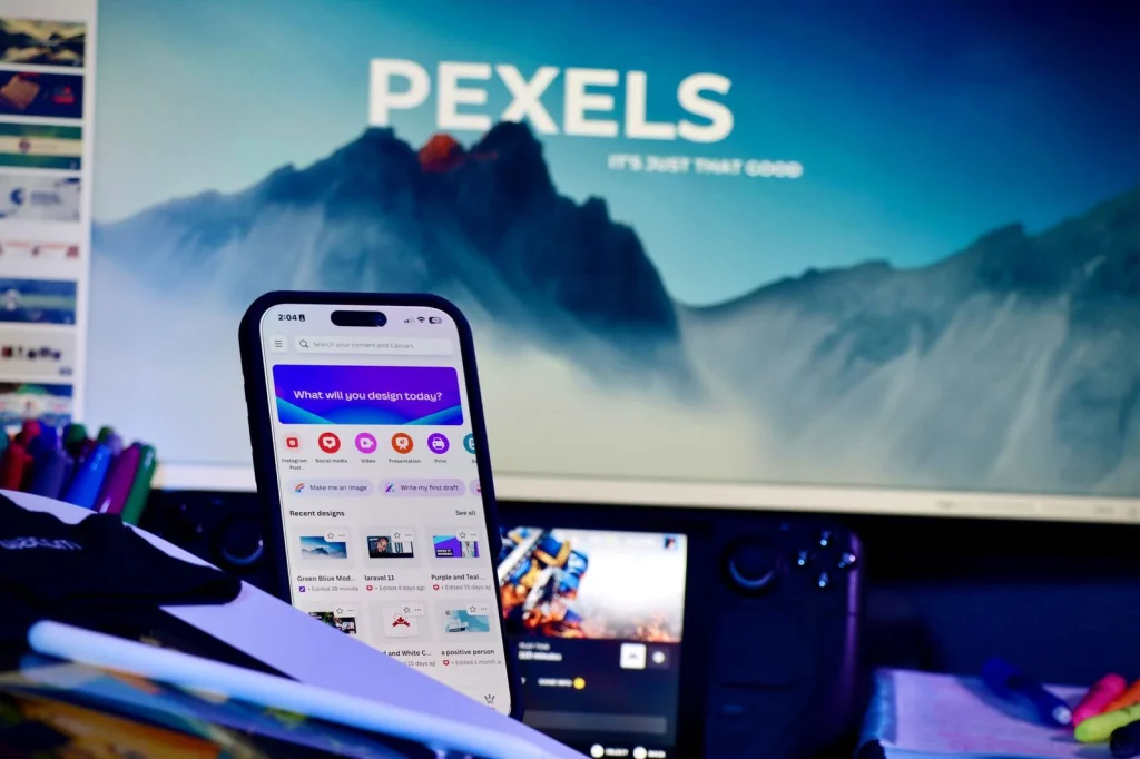 Smartphone displaying PhotoRoom app interface with a product photo being edited, finger touching the screen to remove background, sitting on a white desk with coffee cup nearby, natural window light from the side, close-up angled view, lifestyle tech photography, shallow depth of field